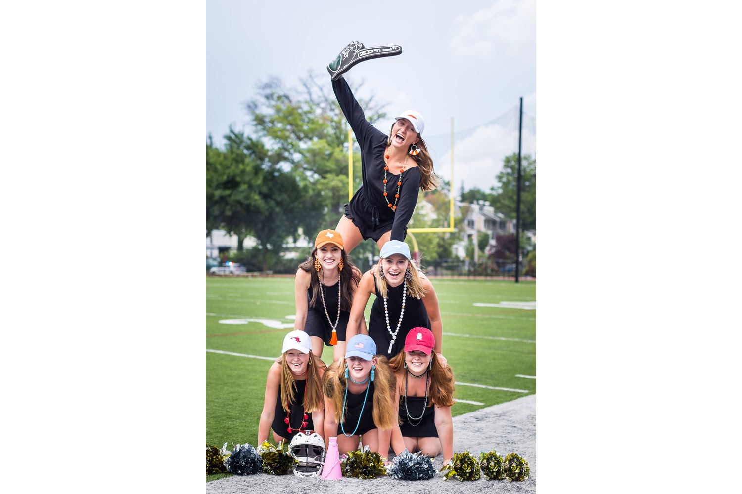Cheer pyramid of female college students wearing Lisi Lerch beaded statement jewelry