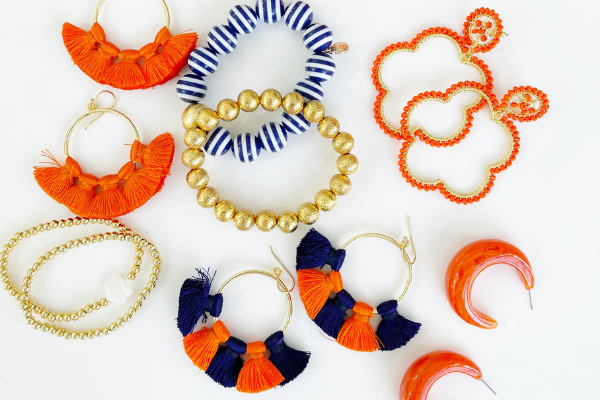 Hoop earrings with a pearl finish and multi-colored accessories in orange, gold, blue and white