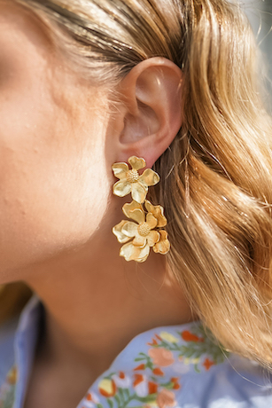 close up of woman wearing lisi lerch gold floral tilly earrings