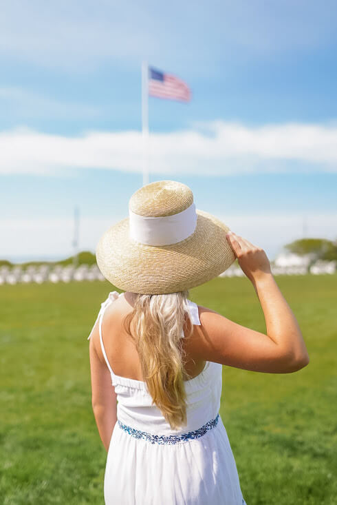 woman in green field wearing white dress and lisi lerch lauren hat