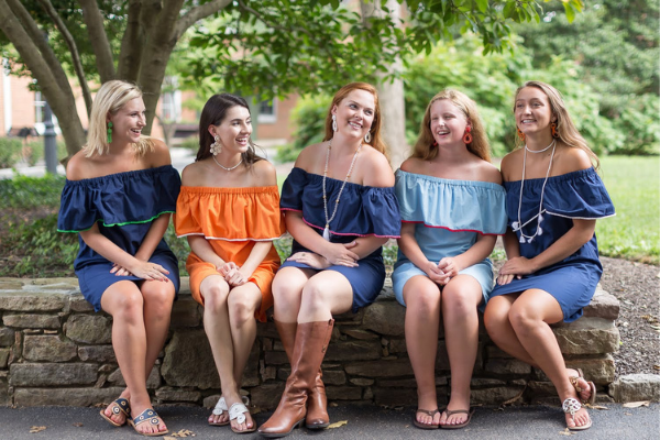 College friends wearing team colors and coordinated Lisi Lerch earrings, necklaces and bracelets