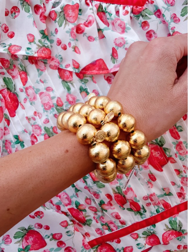 close up of model wearing lisi lerch bracelet with large gold beads